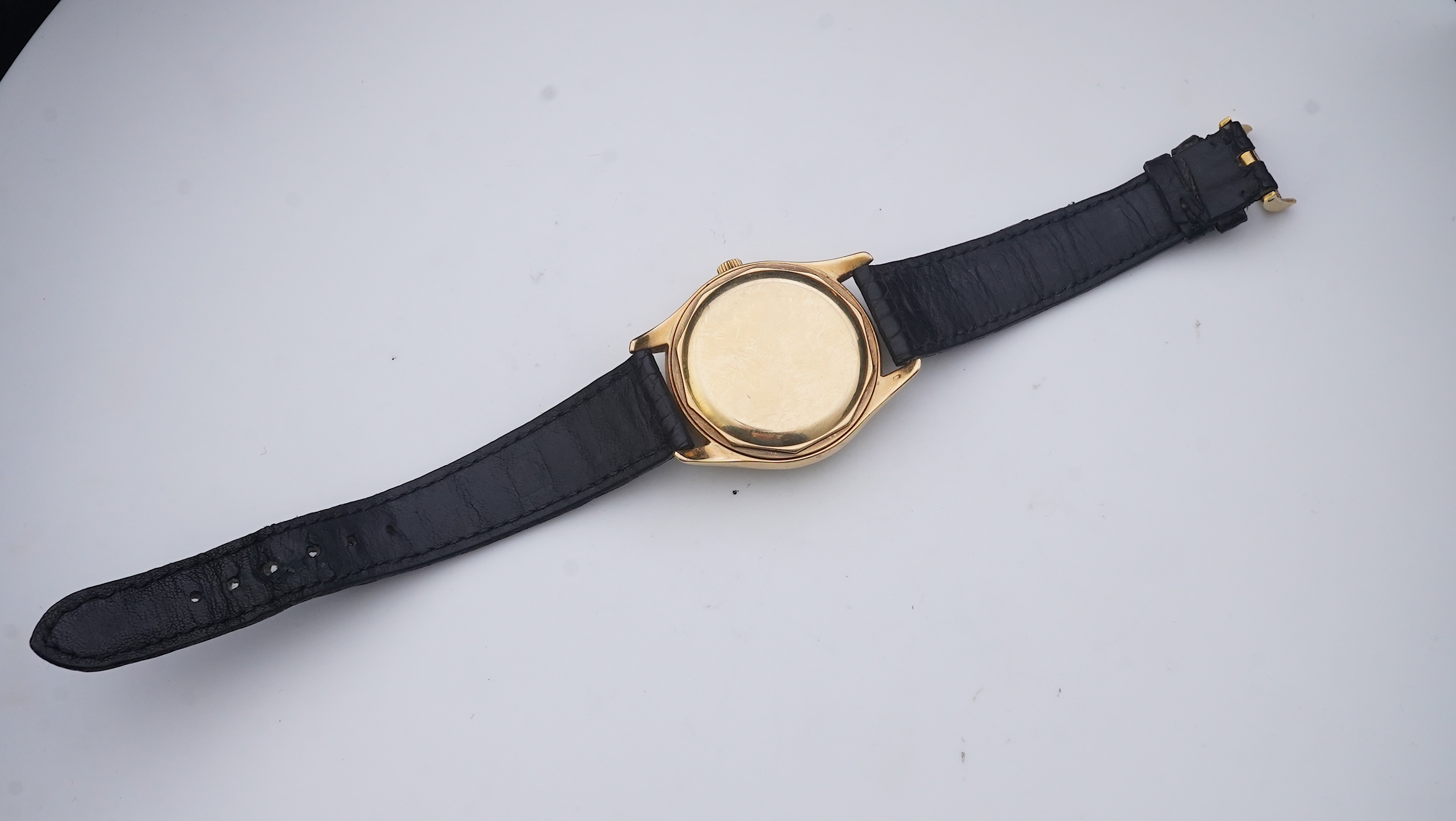 A gentleman's fine 18ct gold Patek Philippe Calatrava automatic wrist watch, model number 2526, on a Patek Philippe black leather strap with a Patek Philippe 18ct gold buckle